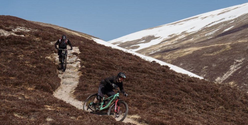 Mountain Biking in Scotland with snow on mountains