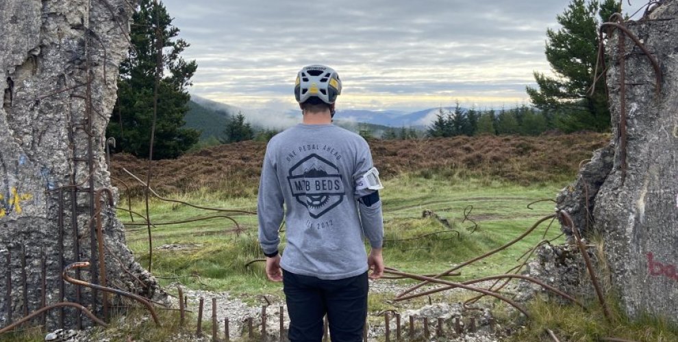 Mountain biker looking at view over the Scottish hills